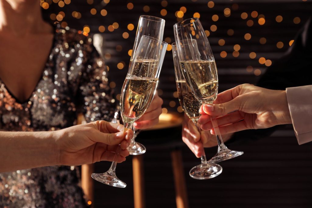 view of champagne glasses toasting