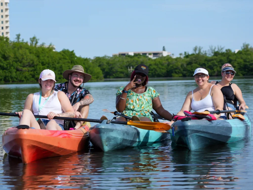 group of friends in kayaks