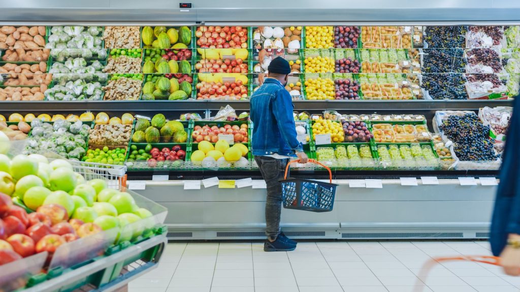 Man shopping at grocery store produce section