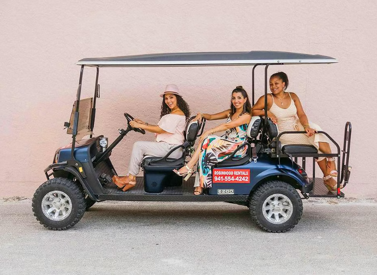 women in golf cart