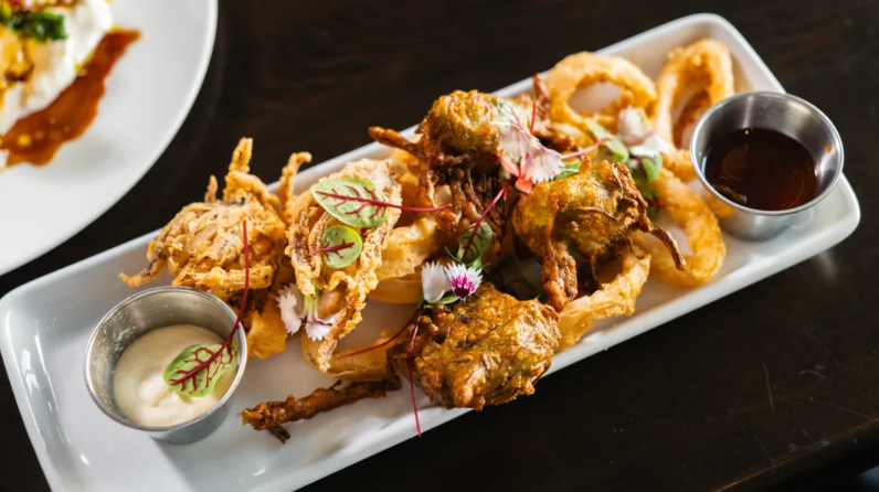 fried dish with sauces and greens