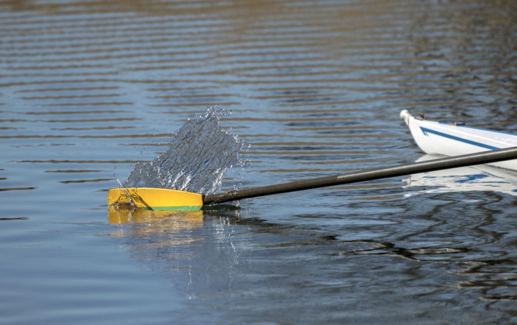 Kayak paddle splashing against the water