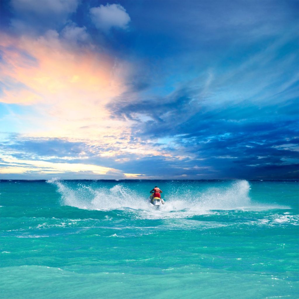 person on a jet ski at sunset