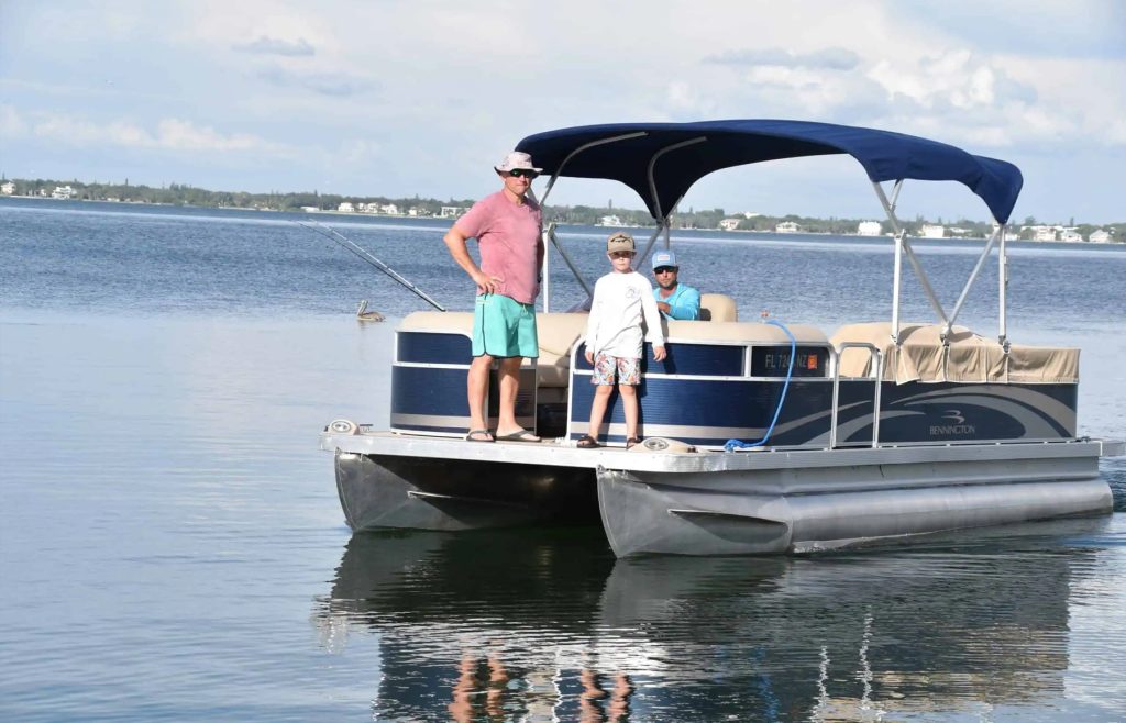 Father and son on pontoon boat 