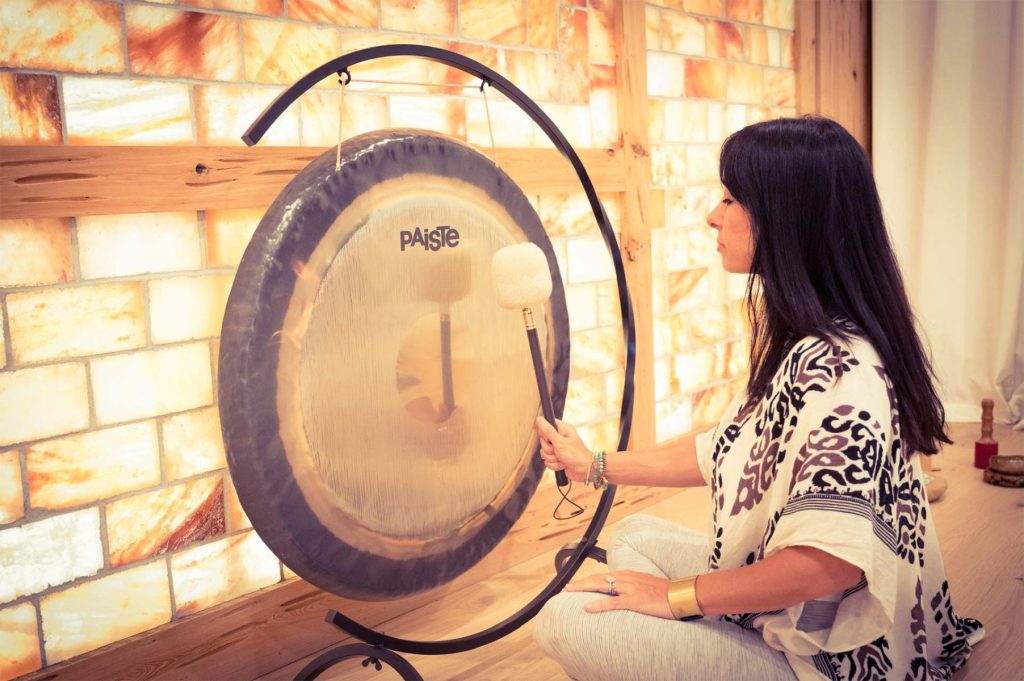 woman playing gong