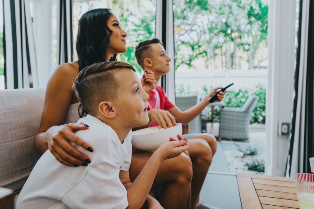 family watching movie in vacation rental